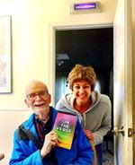 cara bradley taking photo with her book on break